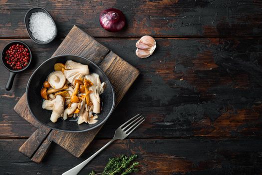 Wild mushrooms Boletus edulis and cap boletus in a jar set, on old dark wooden table background, top view flat lay , with space for text copyspace