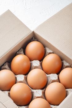 Chicken eggs in an egg box tray set, on white background