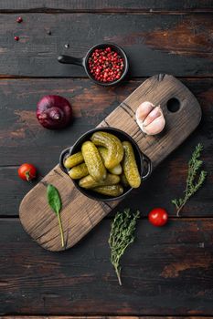 Fermented vegetables Pickled gherkins cucumbers set, on old dark wooden table background, top view flat lay