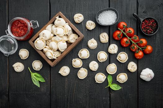 Tortellini ingredients set, on black wooden table background, top view flat lay