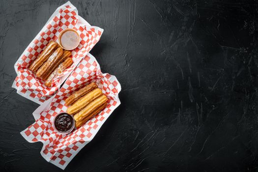 Fried Crullers in Brown, Take Away Bag in paper tray, on black background, top view flat lay with space for text, copyspace