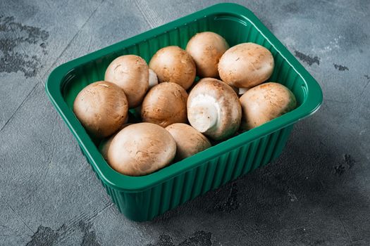 Royal mushrooms champignon whole set, on gray background, in plastic pack