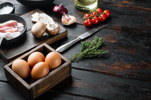 Healthy breakfast ingredients for fried eggs set, on old dark wooden table background , with space for text copyspace