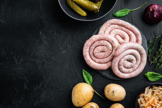 Raw meat sausage set, on black background, top view flat lay , with space for text copyspace