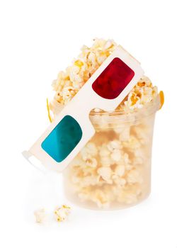 Paper striped bucket with popcorn and 3D glasses isolated on white background with clipping path.