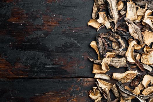 Set of dried mushrooms set, on old dark wooden table background, top view flat lay , with space for text copyspace