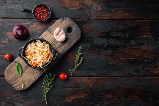 Homemade sauerkraut with cumin set, on old dark wooden table background, top view flat lay , with space for text copyspace