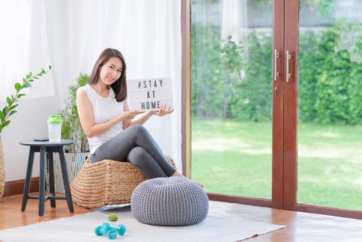 Beautiful asian woman staying fit by exercising at home for healthy trend lifestyle