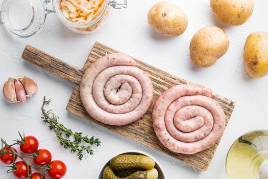 Sauerkraut with grilled sausage, on white background, top view flat lay