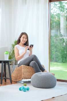 Beautiful asian woman staying fit by exercising at home for healthy trend lifestyle