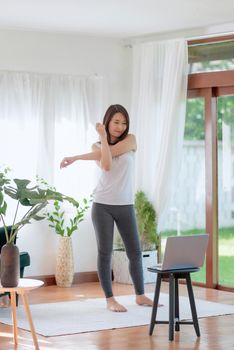 Beautiful asian woman staying fit by exercising at home for healthy trend lifestyle