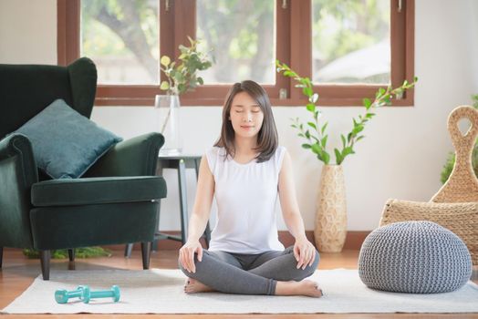 Beautiful asian woman staying fit by exercising at home for healthy trend lifestyle