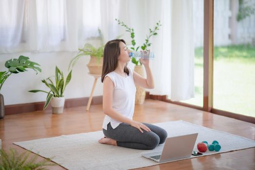 Beautiful asian woman staying fit by exercising at home for healthy trend lifestyle