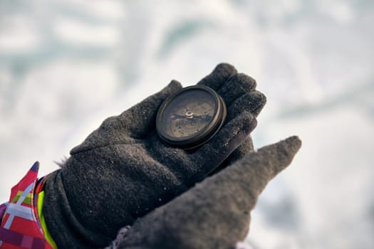 Hiker Hand Holding A Compass And Ices In Background