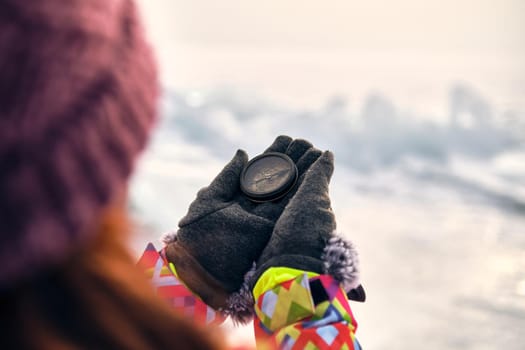 Hiker Hand Holding A Compass And Ices In Background