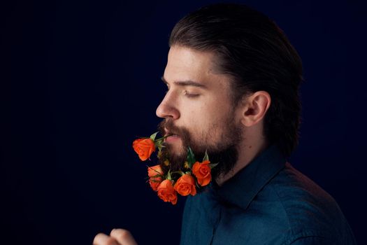 Bearded man holding flowers decoration romance luxury dark background. High quality photo
