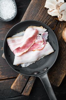 Fresh cold sliced bacon set, on old dark wooden table background, top view flat lay