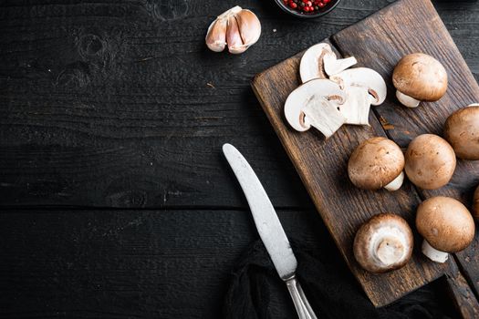 Royal mushrooms champignon whole set, on black wooden table background, top view flat lay , with space for text copyspace