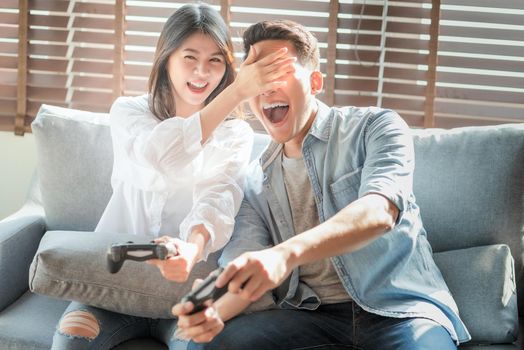 Asian couple lovers enjoy and play console game on vacation make more quality time of happiness together at home