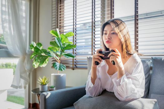 Asian women work from home by casting game streaming online via console game during corona virus or covid19 crisis follow the Social Distancing regulation.