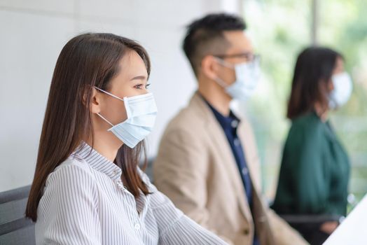 Business employees wearing mask during work in office to keep hygiene follow company policy.Preventive during the period of epidemic from coronavirus or covid19.