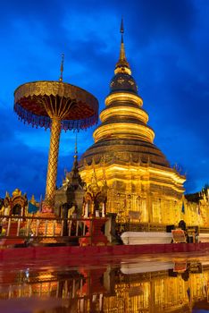 Wat Phra That Hariphunchai with water reflection in Lamphun, Thailand