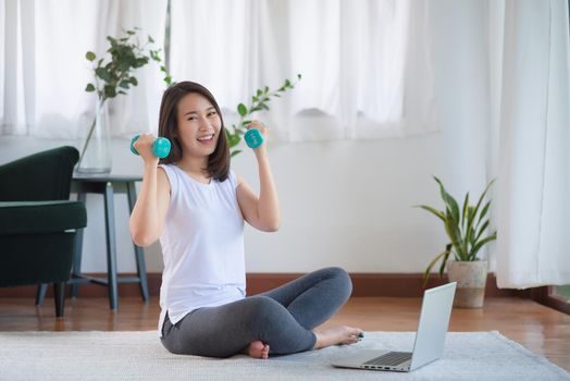 Beautiful asian woman staying fit by exercising at home for healthy trend lifestyle