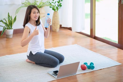 Beautiful asian woman staying fit by exercising at home for healthy trend lifestyle