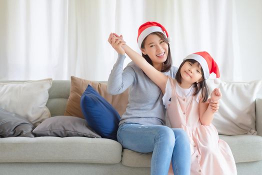 Asian Mother Daughter enjoy to celebrate Christmas and new year party at home in December