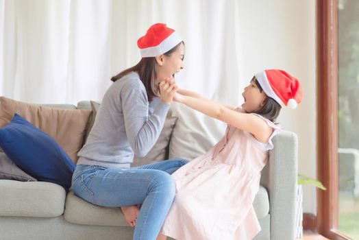 Asian Mother Daughter enjoy to celebrate Christmas and new year party at home in December