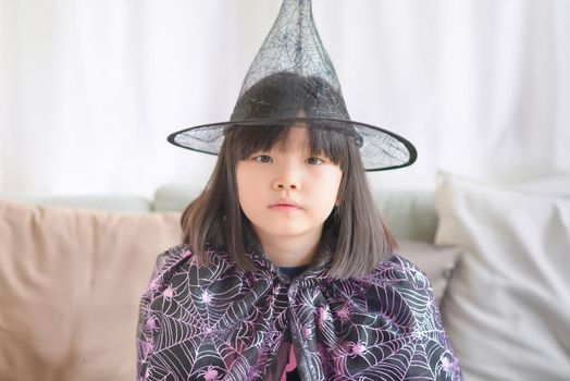 Asian cute kid girl wearing fantasy costume to enjoy Christmas and new year party at home
