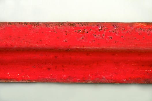 Horizontal metal rusty plate of red color on a light background.Texture or background