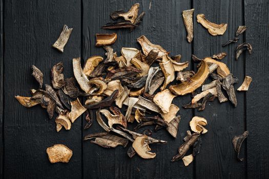 Set of dried mushrooms set, on black wooden table background, top view flat lay