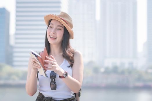Beautiful asian  tourist woman smiling and enjoying the vacation travel in summer.
