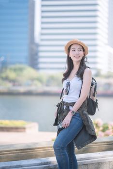 Beautiful asian tourist woman enjoy travel in big city downtown. Vacation travel in summer.