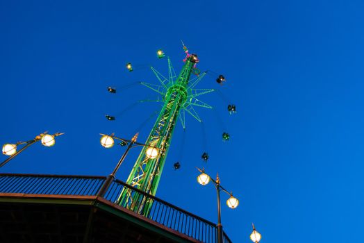The swing ride or chair swing ride in the Tivoli amusement park at night at Copenhagen Denmark