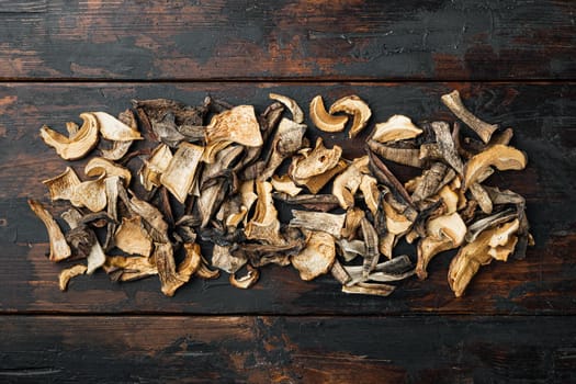 Boletus wild dried mushrooms set, on old dark wooden table background, top view flat lay , with space for text copyspace
