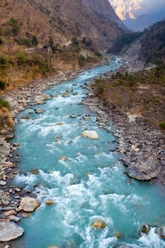 Nature river flowing from mountain along Pooh Hill trekking route with nature forest environment at Nepal.