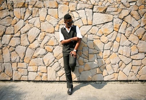 Portrait of young handsome afro black man posing outdoor.