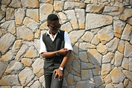 Portrait of young handsome afro black man posing outdoor.