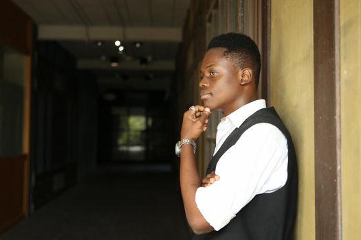 Portrait of young handsome afro black man posing outdoor.