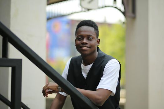 Portrait of young handsome afro black man posing outdoor.