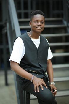 Portrait of young handsome afro black man posing outdoor.