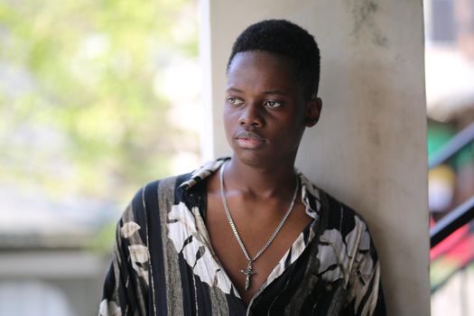 Portrait of young handsome afro black man posing outdoor.