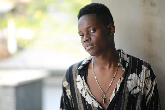 Portrait of young handsome afro black man posing outdoor.