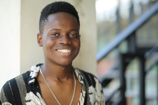 Portrait of young handsome afro black man posing outdoor.