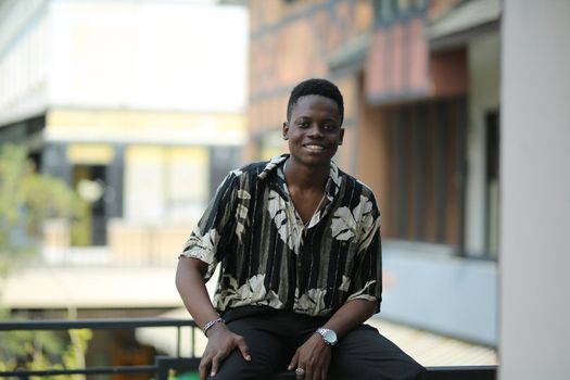 Portrait of young handsome afro black man posing outdoor.