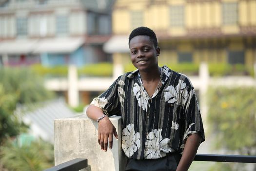 Portrait of young handsome afro black man posing outdoor.