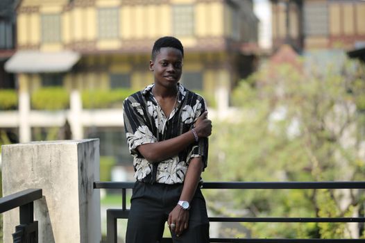 Portrait of young handsome afro black man posing outdoor.