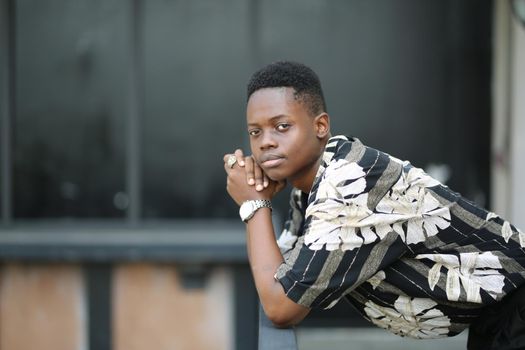 Portrait of young handsome afro black man posing outdoor.